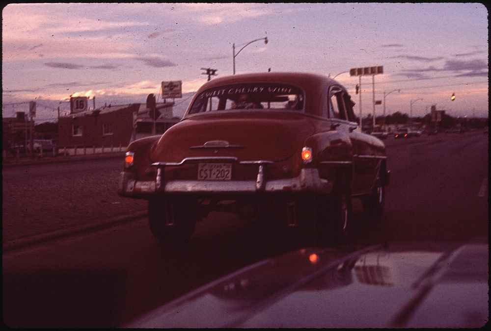 Red retro car on road. Original public domain image from Flickr