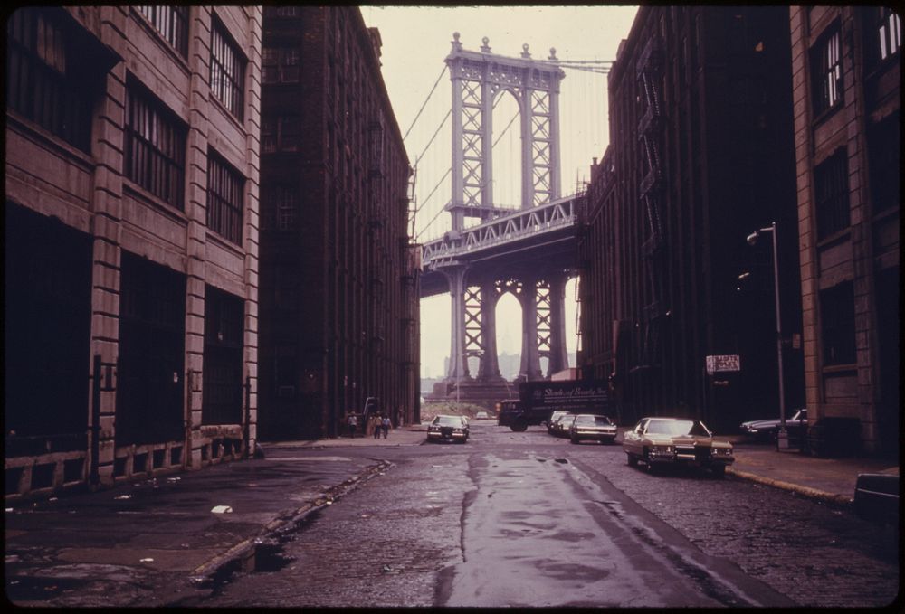 Manhattan Bridge Tower in Brooklyn, New York City, Framed through Nearby Buildings. Original public domain image from Flickr
