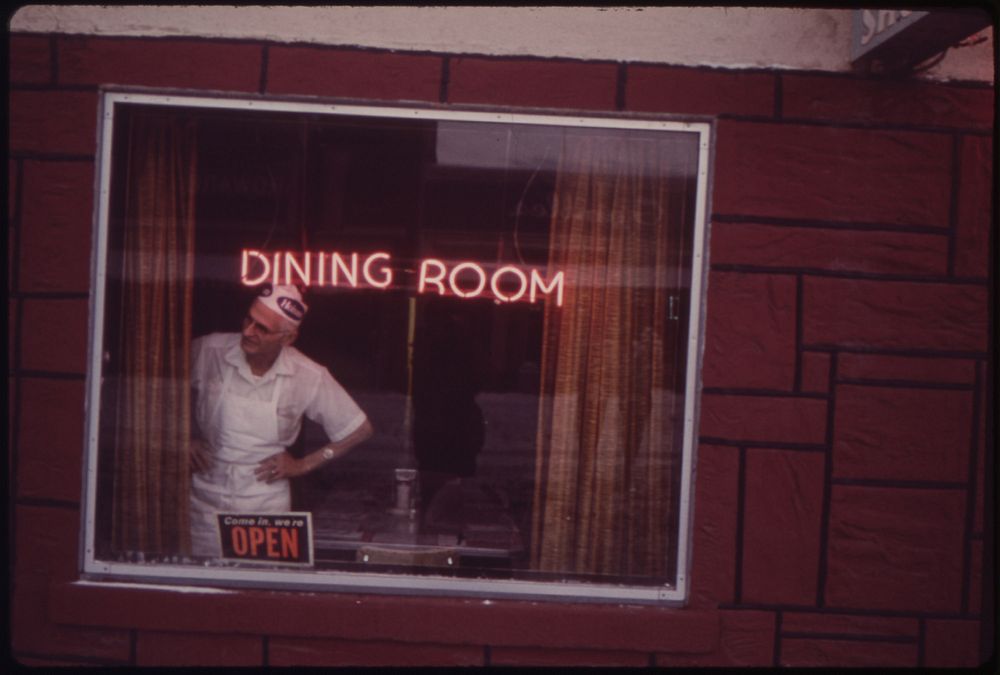 The Cook at Texan Cafe Watches the Snow Removal Crew at Work, 01/1973. Original public domain image from Flickr