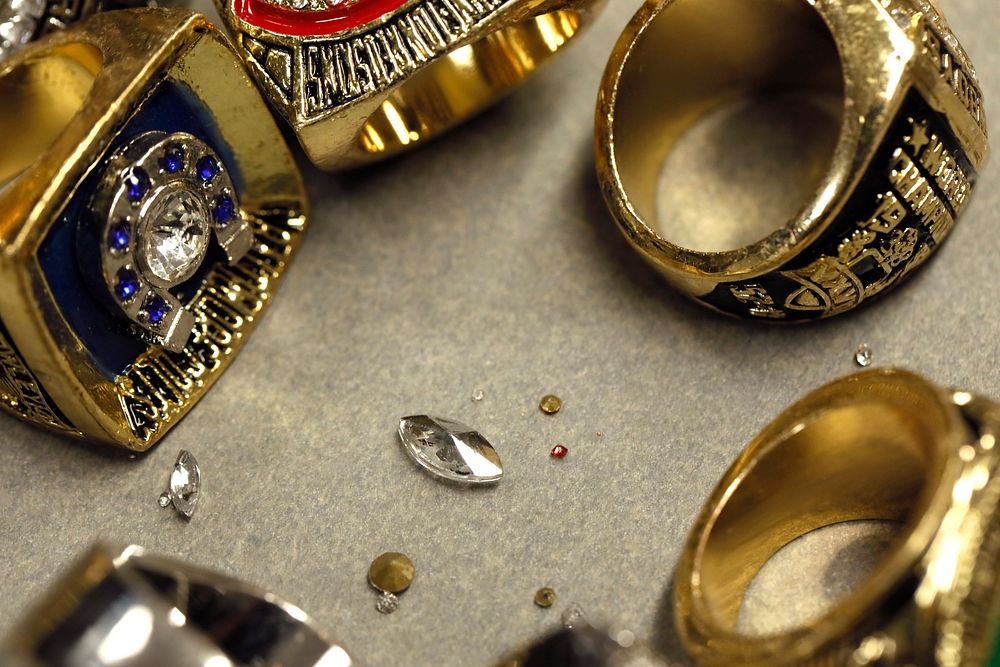 Recently confiscated counterfeit Super Bowl rings lay on a table at a U.S. Customs and Border Protection Office of Field…
