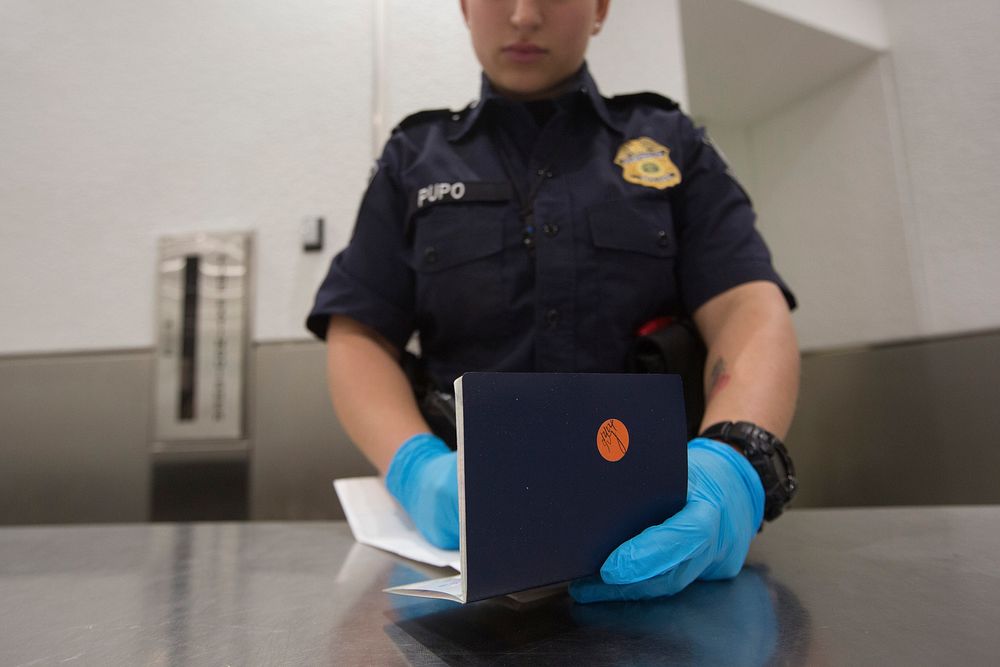 U.S. Customs and Border Protection, Office of Field Operations, officers conduct standard arrival screening operations at…
