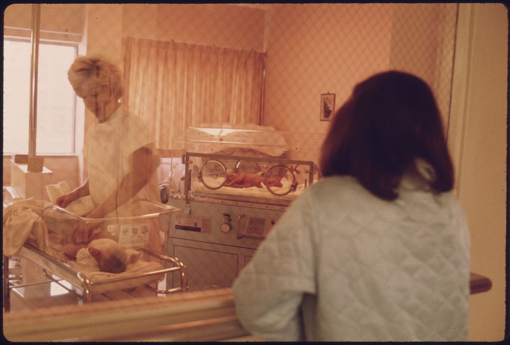 A New Mother Views Her Child in the Nursery of Loretto Hospital in New Ulm, Minnesota.