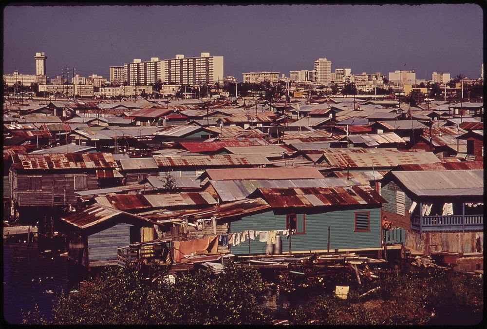 Modern Buildings Tower over the Shanties Crowded Along the Martin Pena Canal. Original public domain image from Flickr
