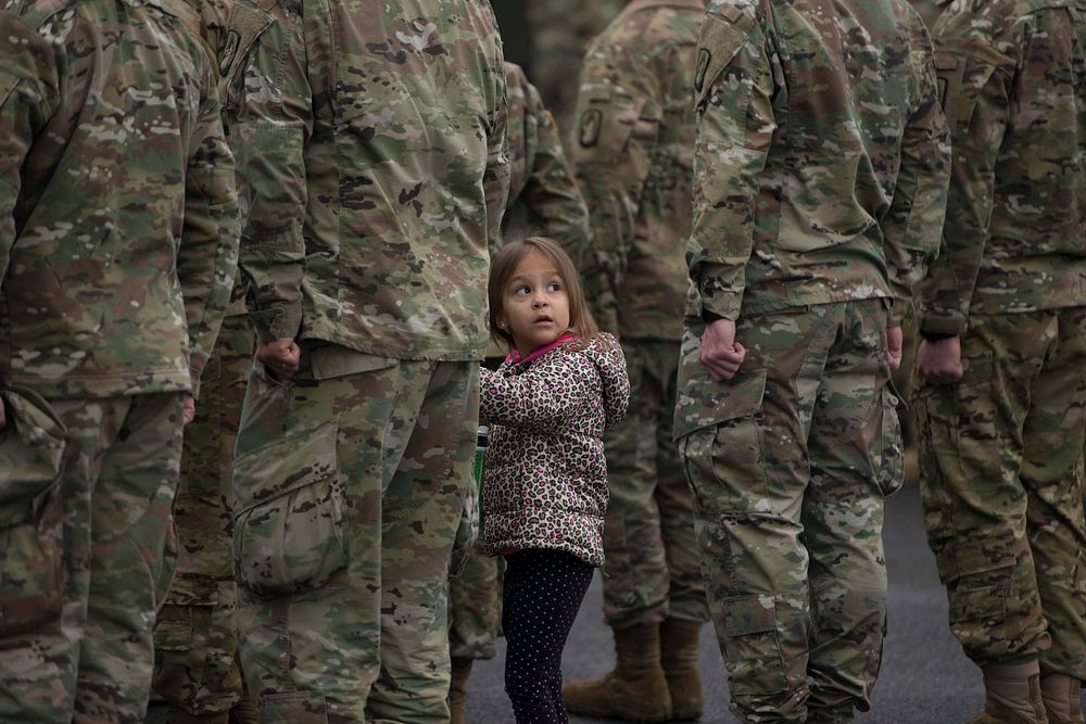 A little girl holds her fathers hand during the 1-214th GSAB annual "Family Safety Day" in Hessen, Germany, March 16, 2018.