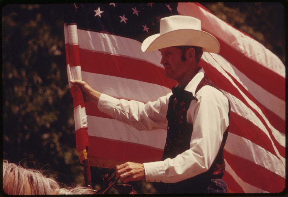 Rider with an American Flag on Horseback in a Parade on the Main Street of Cottonwood Falls, Kansas, near Emporia.