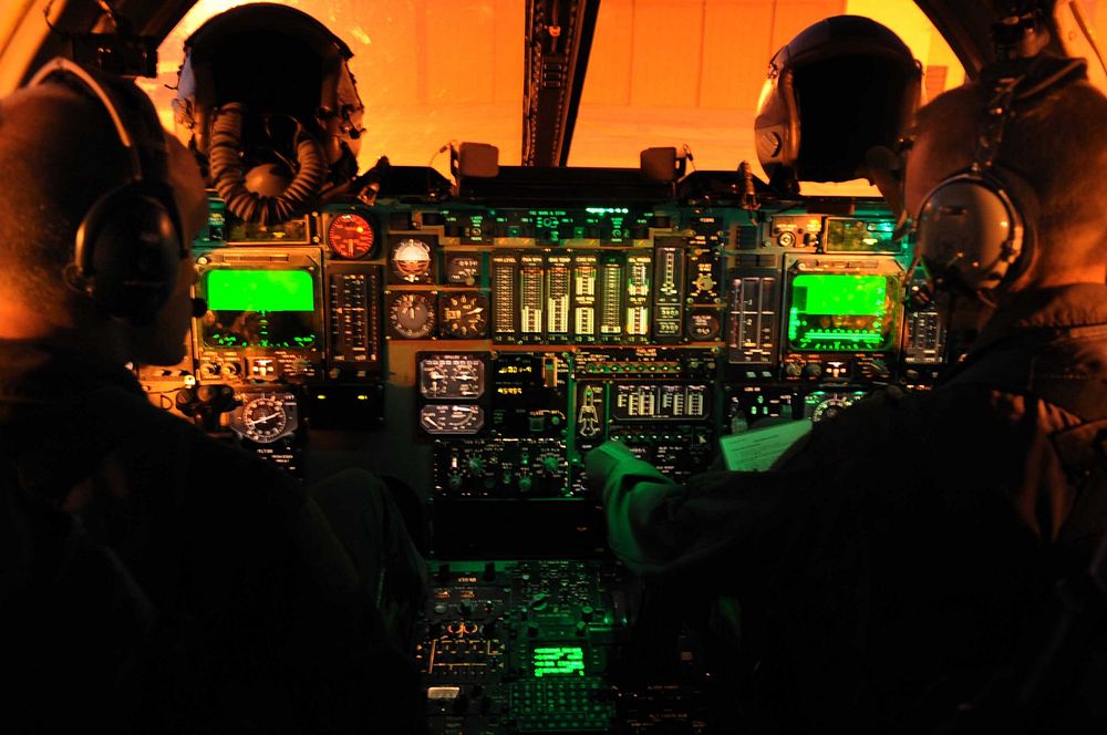 U.S. Air Force Capt. Derek Oakley, left, and Maj. Chris Lovegren, both pilots assigned to the 34th Bomb Squadron, conduct…