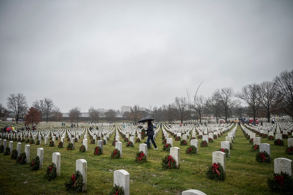 Volunteers lay wreaths in Section 64 during the 27th National Wreaths Across America Day at Arlington National Cemetery…