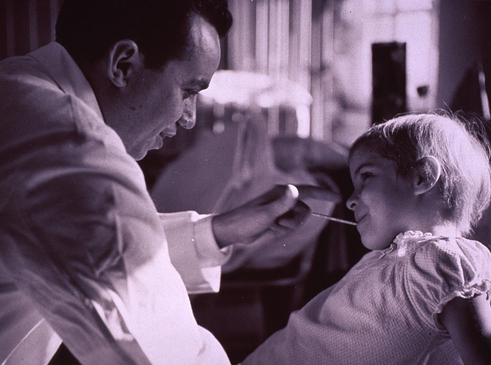 Physician taking temperature of young patient. Original public domain image from Flickr