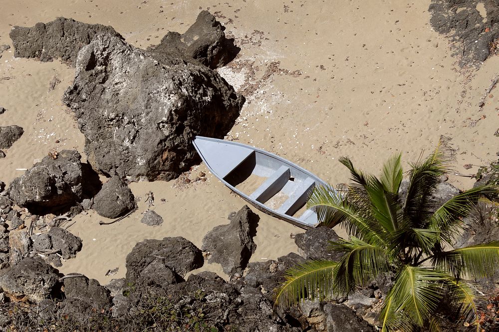 A small, makeshift boat, or "yola," sits abandoned on a remote beach near Aguadilla, Puerto Rico, April 3, 2019.