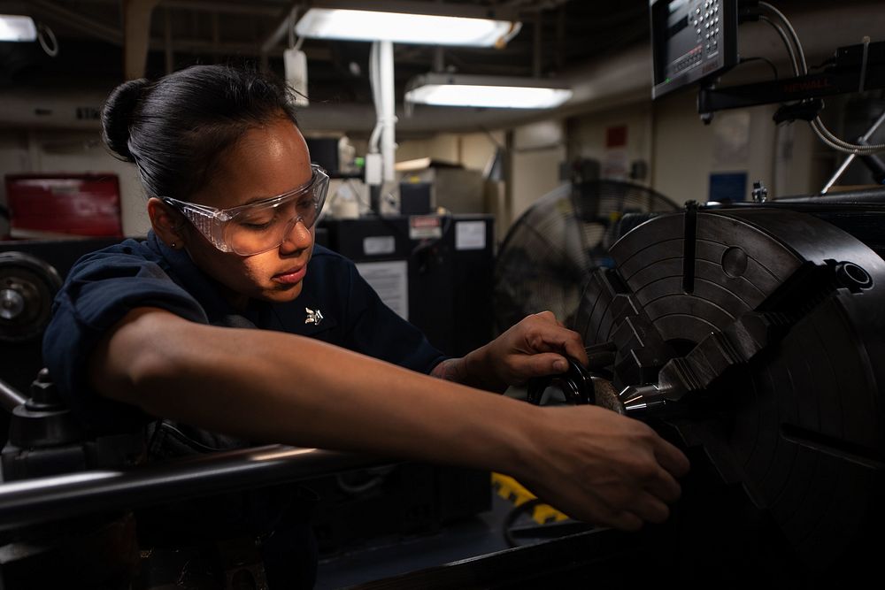 U.S. Navy Machinery Repairman 2nd Class Angelica Cotto, from Caguas, Puerto Rico, measures a section of steel in the…