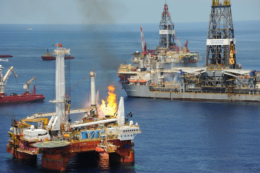 The drillship Discoverer Enterprise, right, and other vessels conduct flaring operations to mitigate the effects of the…