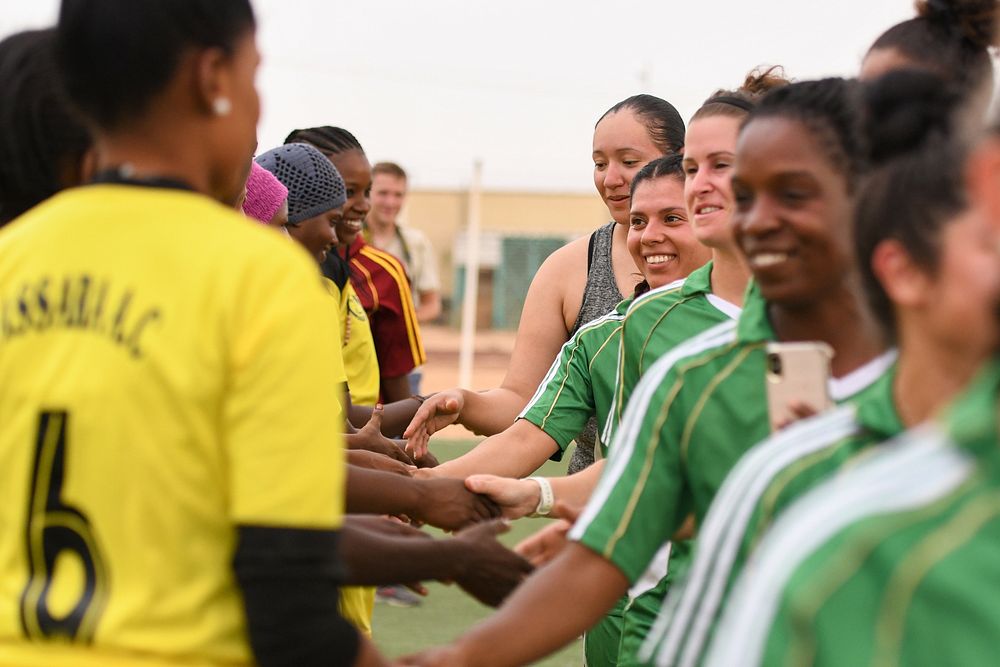 U.S. Air Force women deployed to Nigerien Air Base 201 and the Nassara Athletic Club Women’s Soccer Team shake hands after a…