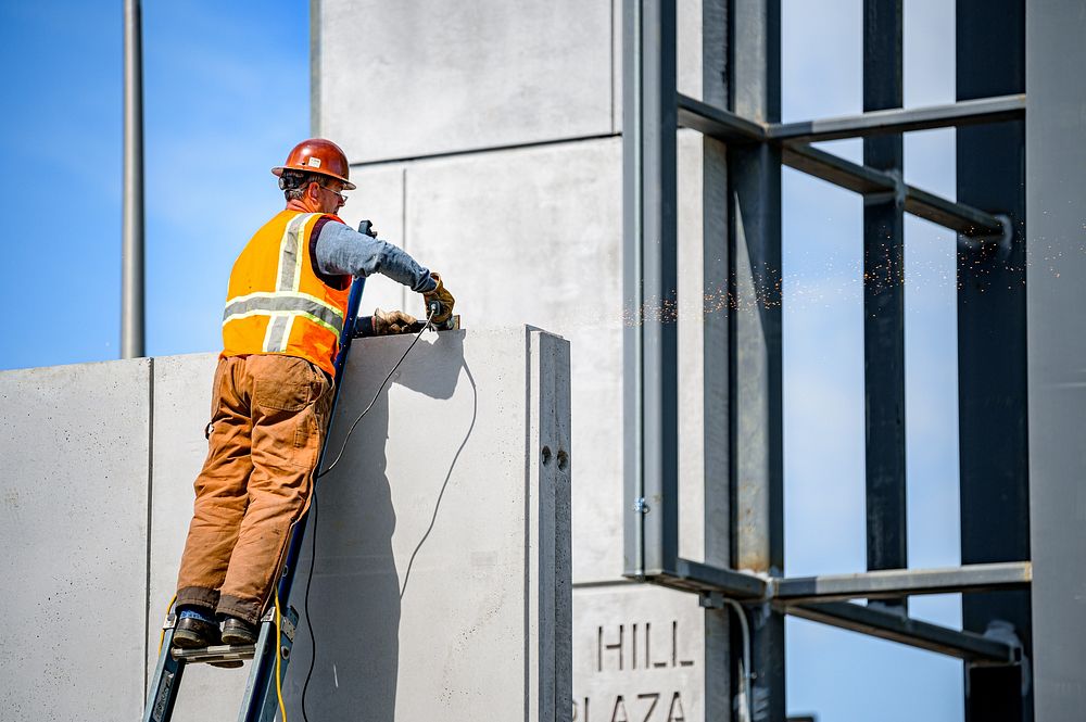 Contractors begin putting the finishing touches on concrete work during construction of Sycamore Hill Gateway Plaza, April…