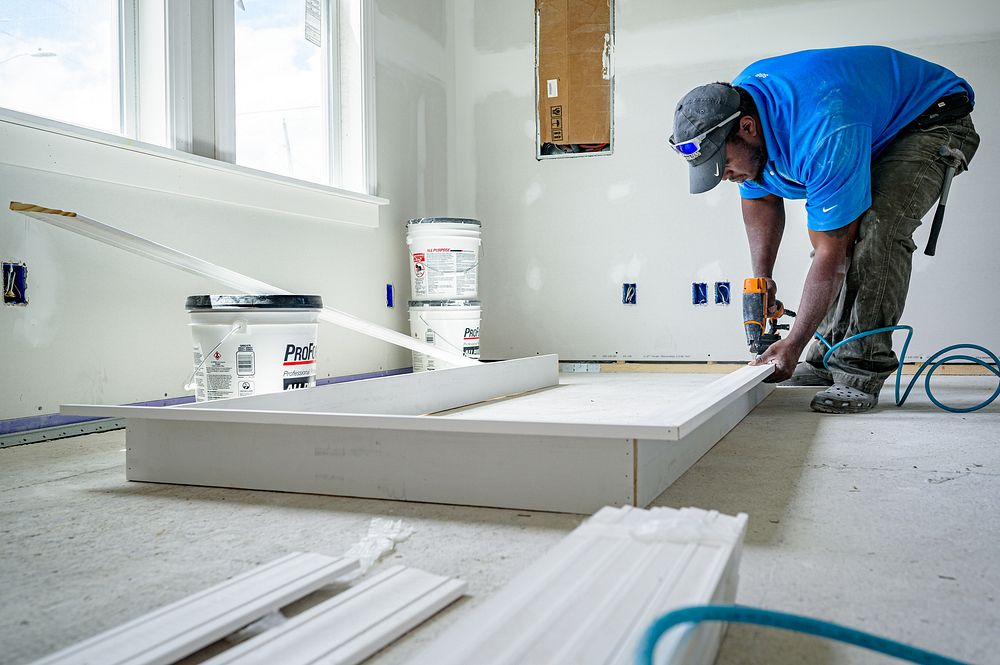 Interior doorway trim is constructed and installed in a home undergoing rehabilitation through the City of Greenville's…