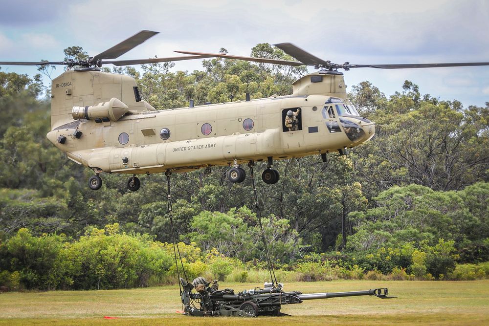 SCHOFIELD BARRACKS, Hawaii - A 25th Infantry Division CH-47 Chinook carries a sling load with a M777 Howitzer in preparation…