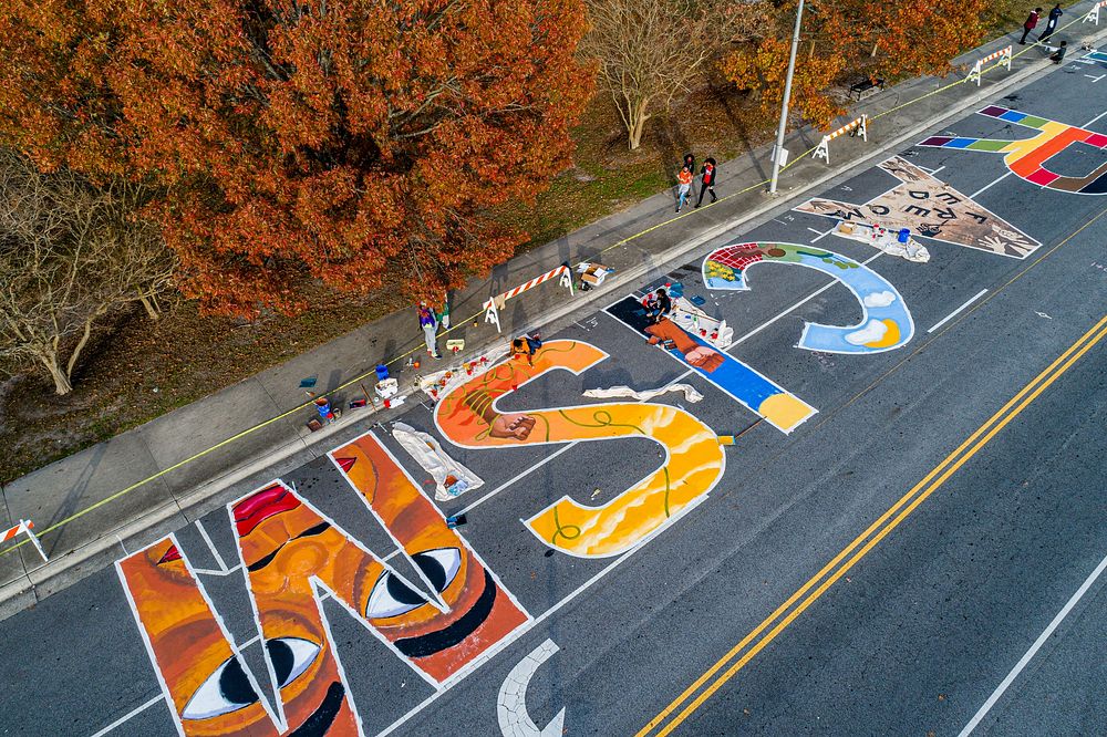 Artists continue painting the 1st Street Mural, December 12, 2020, North Carolina, USA. Original public domain image from…
