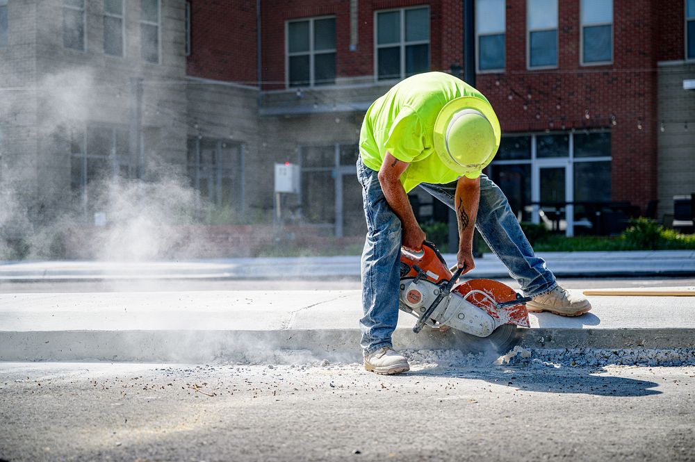 Construction crews prepare for paving along Reade Circle while drain pipe and junctions are installed along W 8th St, July…