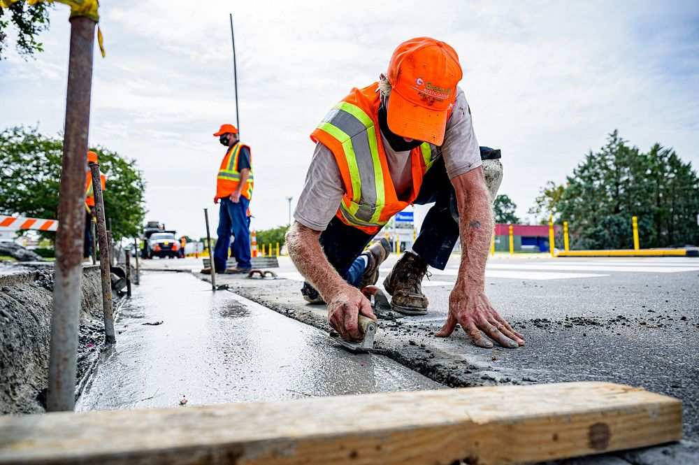 Public Works Streets Division constructs an ADA-compliant crosswalk ramp on E 10th Street, August 28. Original public domain…