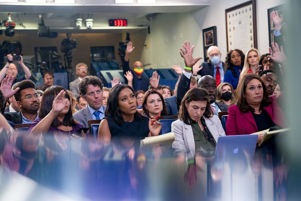 Reporters raise their hands during a press briefing by Press Secretary Jen Psaki on Friday, July 16, 2021, in the James S.…