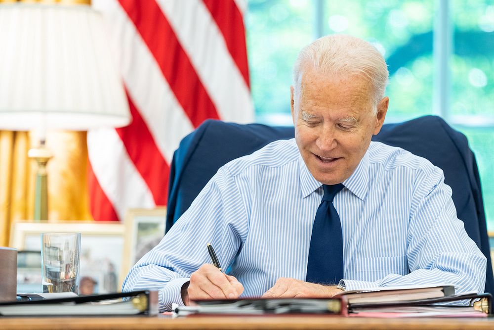 President Joe Biden talks on the phone with U.S. Senator Tom Carper, D-Del., during congressional call time on Friday, July…