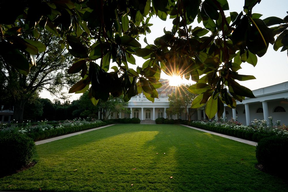 The sunset is seen from the Rose Garden of the White House. Original public domain image from Flickr