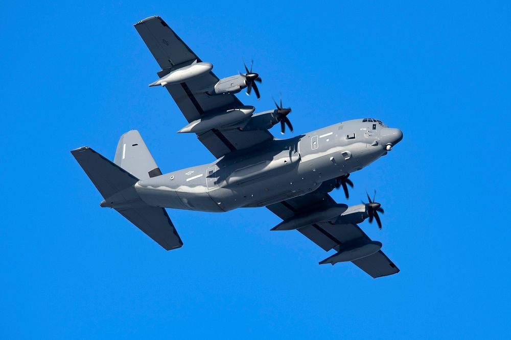 An Air Force MC-130J Commando II passes over Malemute Drop Zone during airborne operations. Original public domain image…