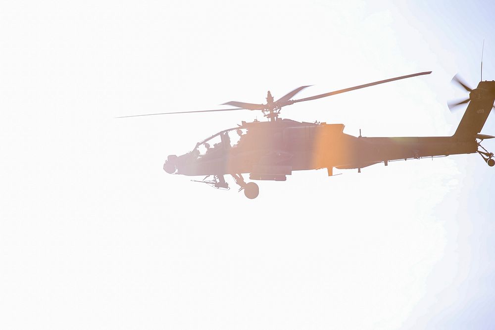 Flying helicopter, bright sunlight.