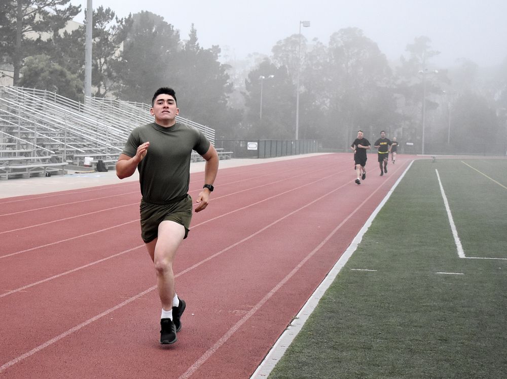 A soldier running on running track. Original public domain image from Flickr