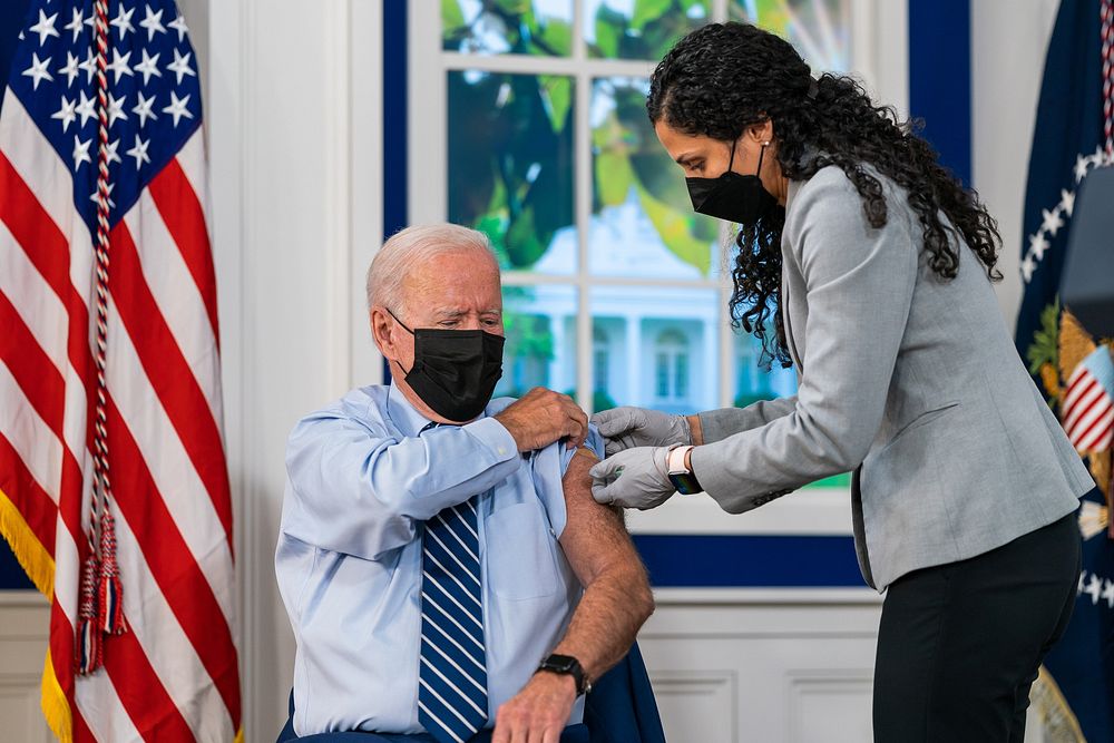 President Joe Biden receives a COVID-19 booster shot in the South Court Auditorium of the Eisenhower Executive office…