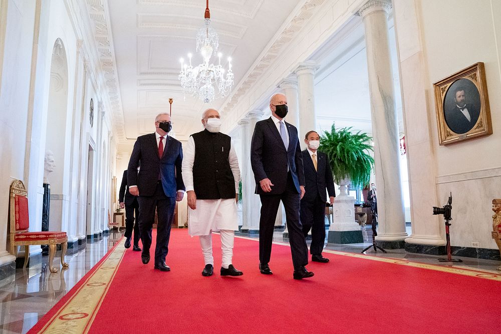 President Joe Biden walks through the White House Cross Hall with, from left, Australian Prime Minister Scott Morrison…