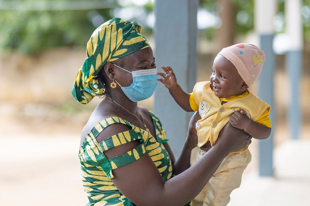 Mother and child pictured outside Cameroon health facility, September 22, 2021.  Original public domain image from Flickr