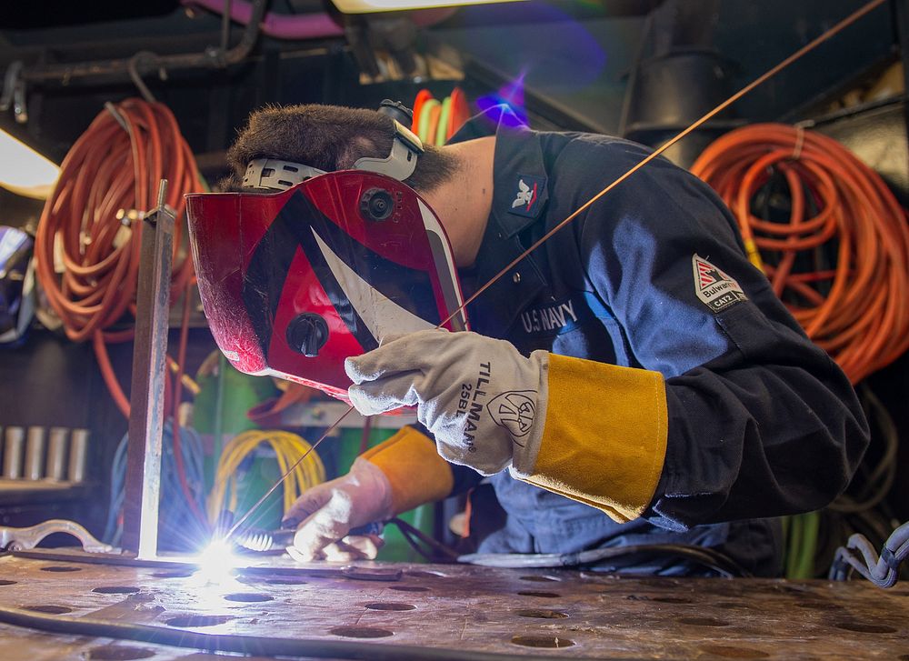 Hull Technician 3rd Class Kyle Mehle, from Bedford, Pennsylvania, welds carbon steel stock aboard the Nimitz-class aircraft…