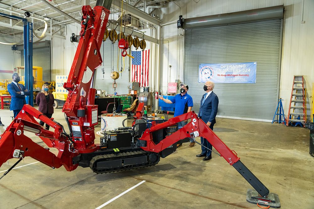 President Joe Biden tours the main shop area at the Operating Engineers Training Facility in Howell, Michigan, Tuesday…