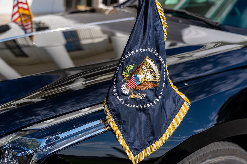 The Presidential flag flies on the hood of the Presidential limousine as President Joe Biden and First Lady Jill Biden board…