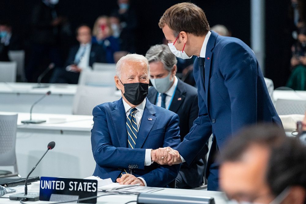 President Joe Biden greets French President Emmanuel Macron during the opening session of the U.N. Climate Change Conference…