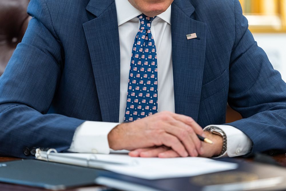 President Joe Biden wears an American flag tie during a meeting with Treasury Secretary Janet Yellen and economic advisers…