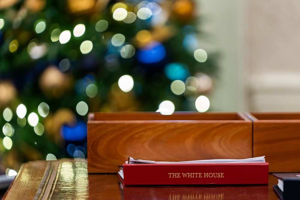 Binders sit on the Resolute desk as President Joe Biden works in the Oval Office, Tuesday, November 30, 2021. (Official…