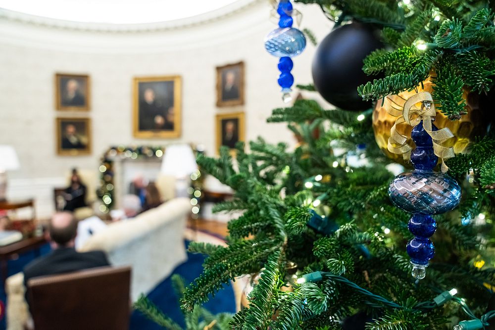 Holiday decorations are seen in the Oval Office as President Joe Biden and Vice President Kamala Harris participate in a…