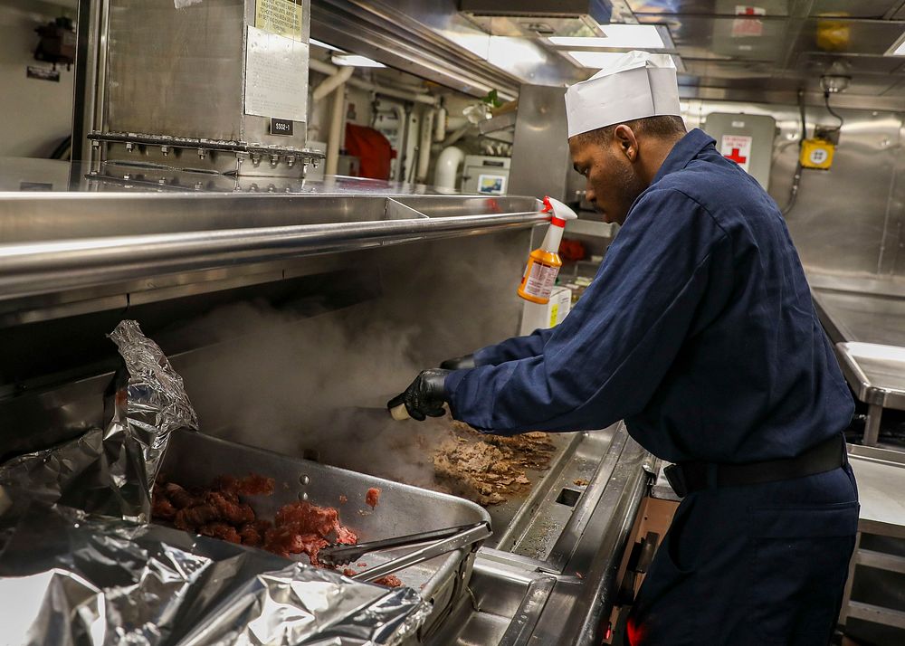 USS Porter (DDG 78) Prepares LunchNORTH SEA (Jan. 29, 2022) – Culinary Specialist 3rd Class Gerrard Blount prepares shredded…