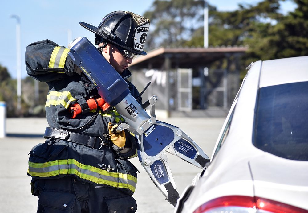 Firefighter using Jaws of Life. Original public domain image from Flickr