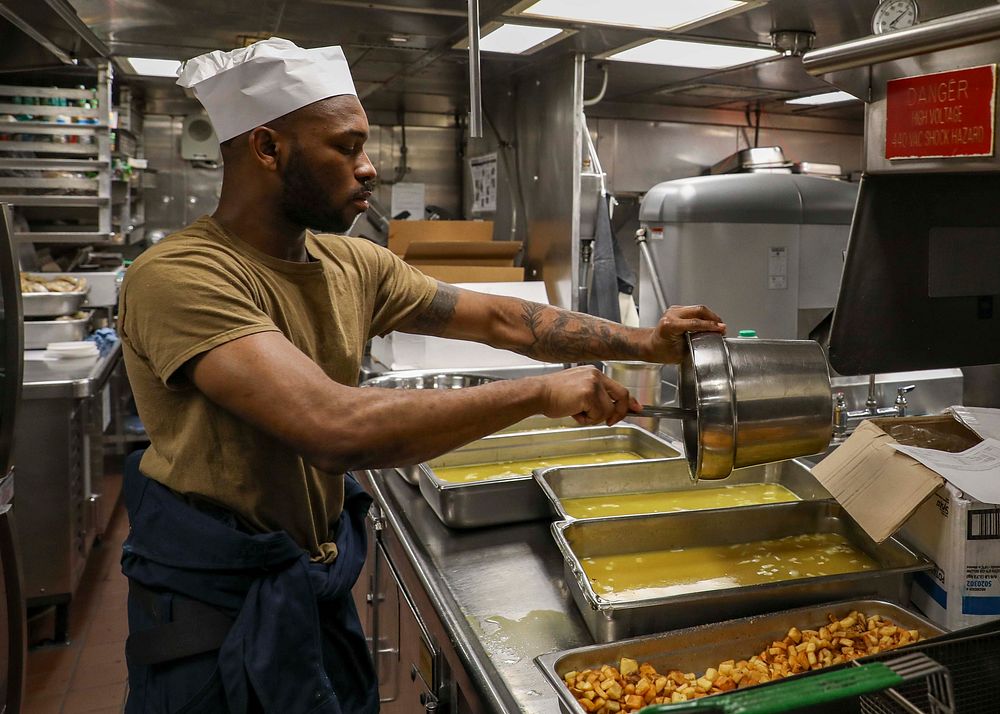 USS Porter (DDG 78) Chow TimeATLANTIC OCEAN (March 16, 2022) – Culinary Specialist 3rd Class Gerrard Blount prepares rice…
