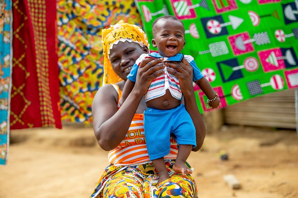 Mother and child outside their home.