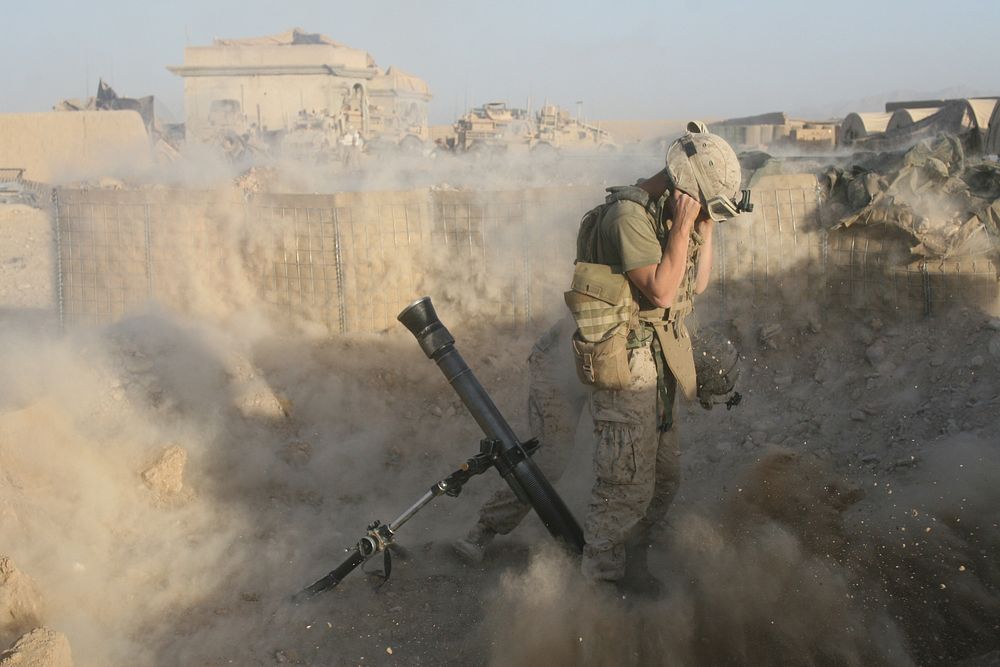 A U.S. Marine fires a mortar round during combat operations at Forward Operating Base Nolay, Afghanistan, Oct. 19, 2010.