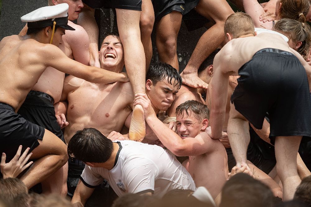 U.S. Naval Academy freshmen, plebes, climb the Herndon Monument, a tradition symbolizing the successful completion of the…