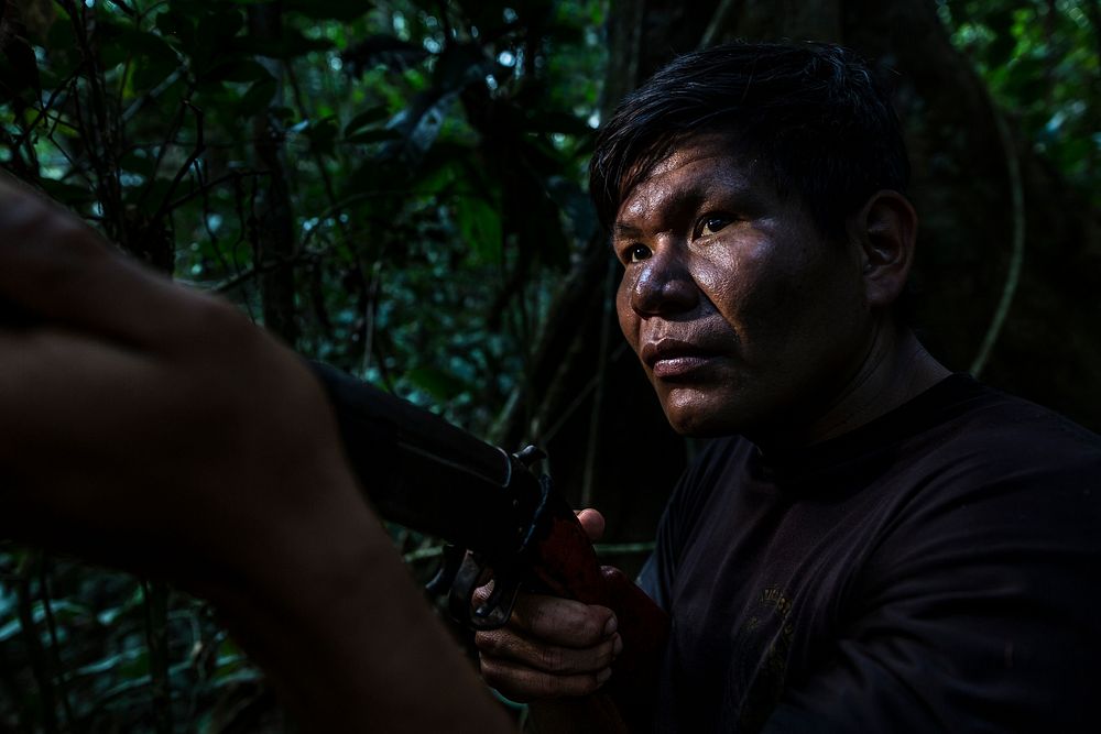Man holding gun in the Amazon rainforest. August 27, 2016. (USDA Forest Service photo by Diego Perez) Original public domain…