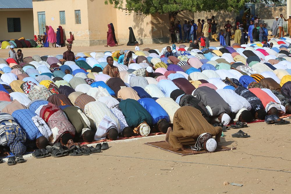 Worshippers pray on Eid al-Adha at Hawo Tako School. AMISOM Photo. Beletweyne, Somalia, July 20, 2021. Original public…