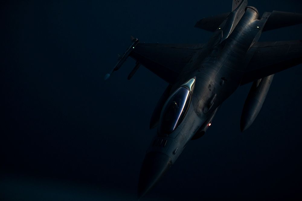 A U.S. Air Force F-16C Fighting Falcon with the 119th Fighter Squadron moves away from a 141st Air Refueling Squadron KC…