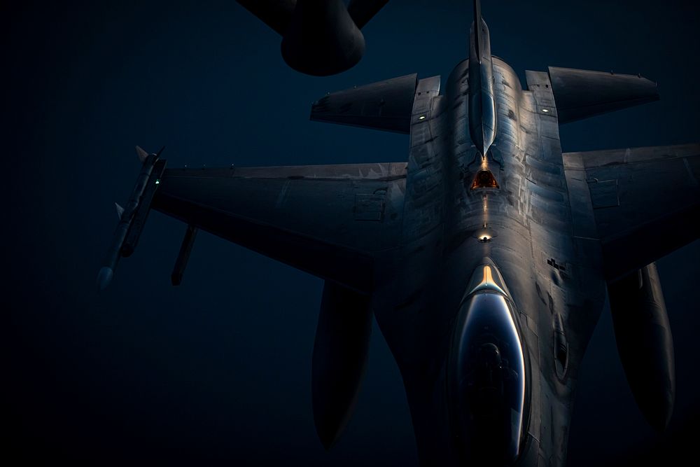 A U.S. Air Force F-16C Fighting Falcon with the 119th Fighter Squadron moves away from a 141st Air Refueling Squadron KC…
