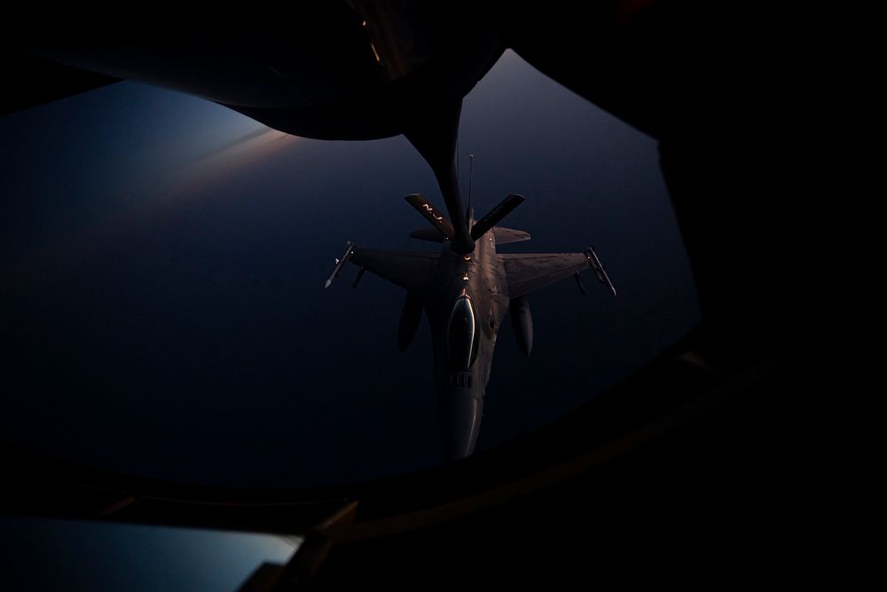 A U.S. Air Force F-16C Fighting Falcon with the 119th Fighter Squadron is refueled by a 141st Air Refueling Squadron KC-135R…