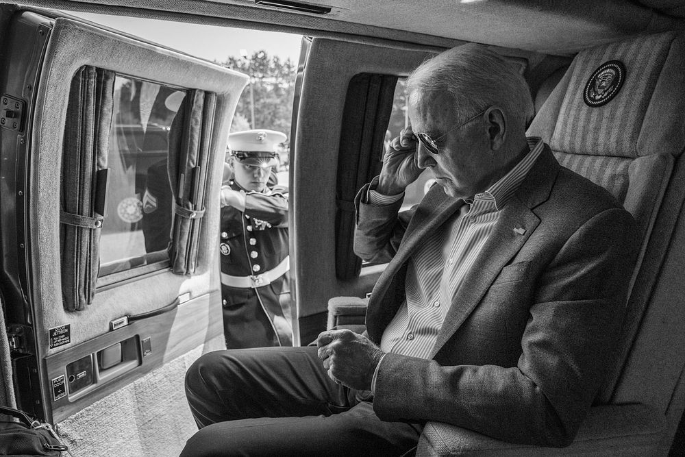A U.S. Marine opens the door as President Joe Biden prepares to disembark Marine One, Saturday, July 3, 2021, at Antrim…